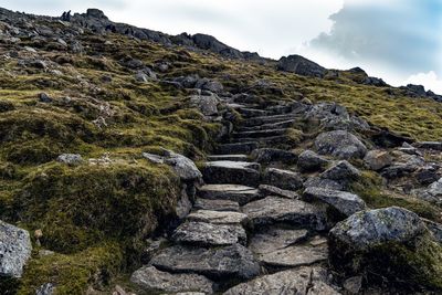 Low angle view of a rocky path on mountain against sky