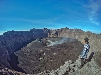 Man looking at view on volcanic landscape