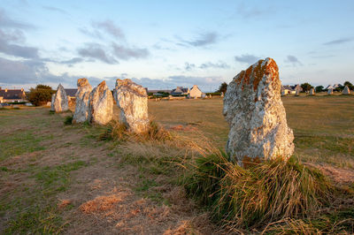 Panoramic view of rocks on field against sky