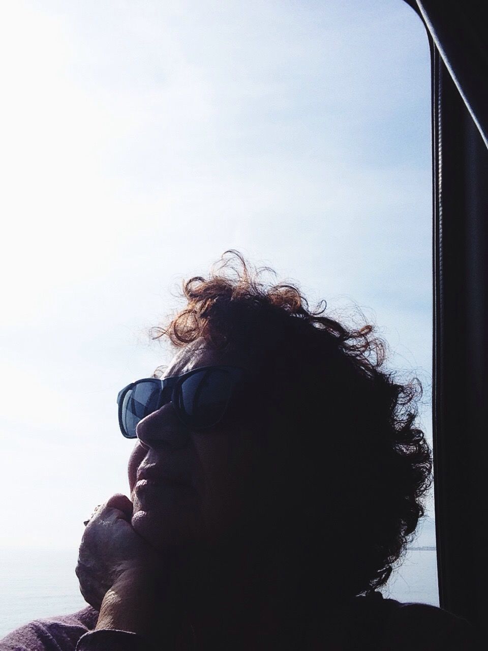 lifestyles, headshot, leisure activity, sky, waist up, rear view, head and shoulders, water, young adult, young women, person, sea, long hair, three quarter length, silhouette, window, day, standing