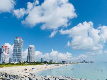 Panoramic view of beach and buildings against sky