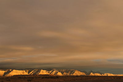 Scenic view of mountains against orange sky