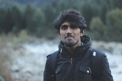 Portrait of smiling young man standing outdoors