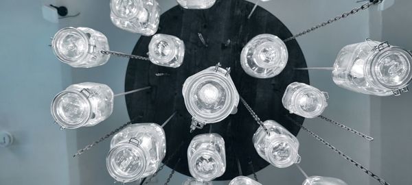 Low angle view of illuminated chandelier hanging from ceiling