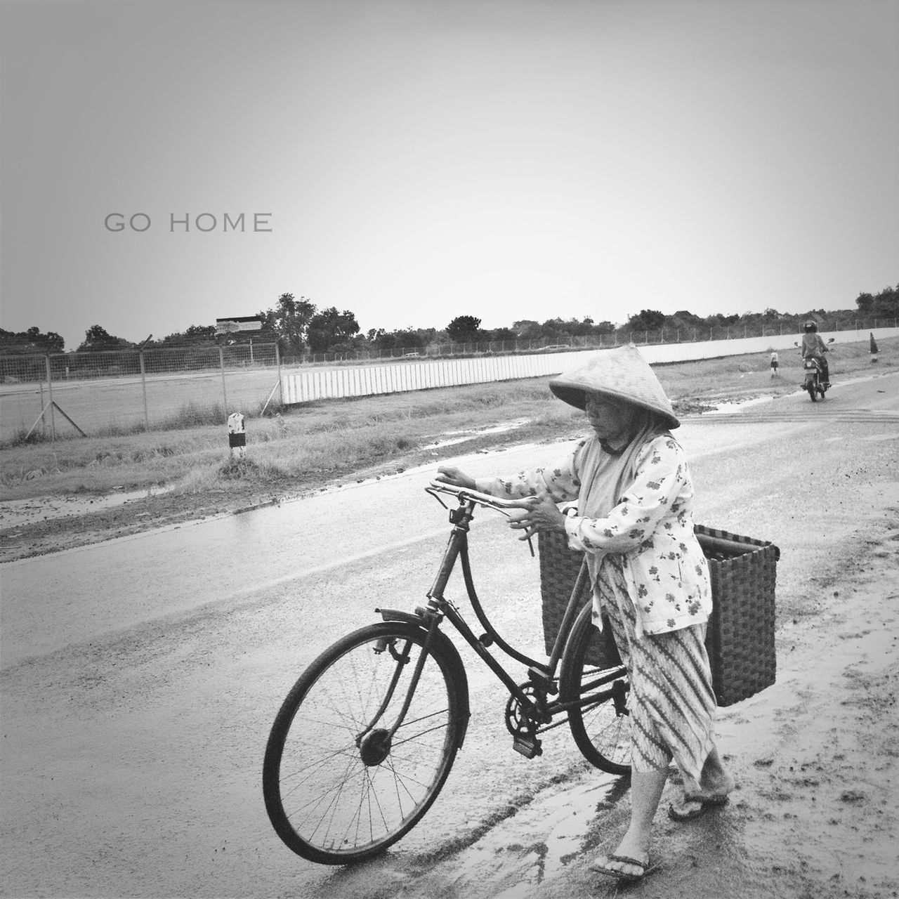 transportation, bicycle, land vehicle, mode of transport, clear sky, road, text, stationary, copy space, parking, western script, parked, landscape, street, day, communication, outdoors, no people, sand, field