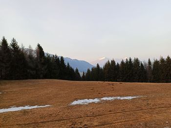 Scenic view of snow covered land against sky