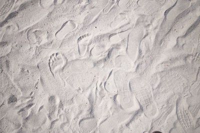 High angle view of footprints on sand