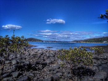 Scenic view of sea against blue sky