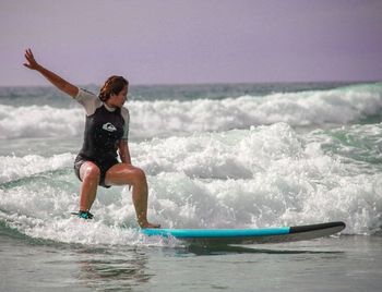 Woman surfing on sea