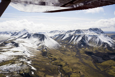Aerial view of icelandic mountains from airplane wing pov