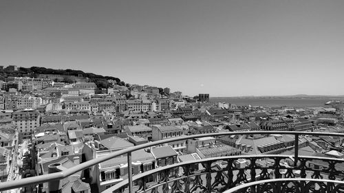 Buildings against clear sky seen through observation point during sunny day