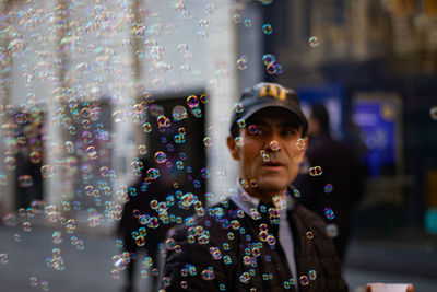 Portrait of young man looking at bubbles