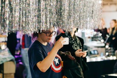 Midsection of man using mobile phone