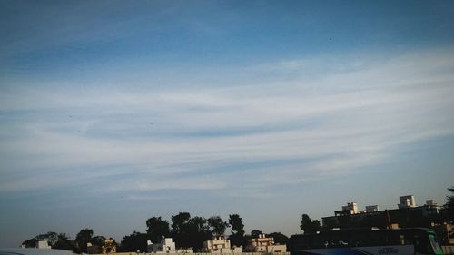 Buildings against cloudy sky