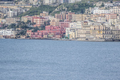 Aerial view of sea and buildings in city