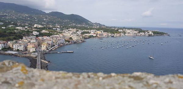 High angle view of townscape by sea against sky