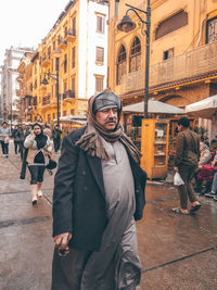 Portrait of people standing on street in city