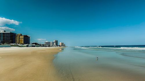 Scenic view of beach against sky in city