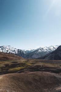 Scenic view of snowcapped mountains against clear sky