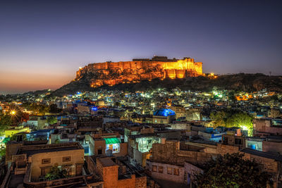 High angle view of illuminated buildings in city at night