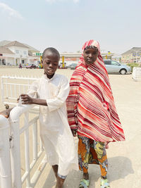 Nigerian girl and boy standing on a street