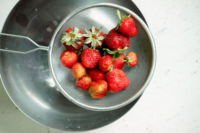 Bright sweet and juicy strawberries . red strawberries in an iron colander. drops of water a berries