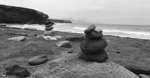 Rocks on beach against sky