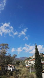 Houses against cloudy sky