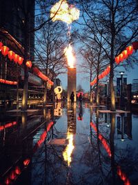 Reflection of illuminated street lights in canal