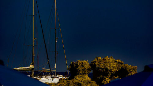 Sailboats in sea against clear blue sky