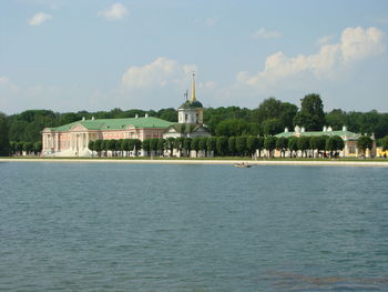 Building by sea against sky
