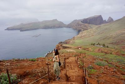 Scenic view of sea and mountains against sky