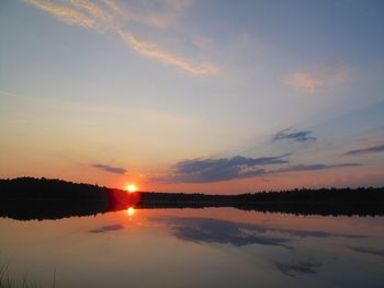 Scenic view of calm lake at sunset