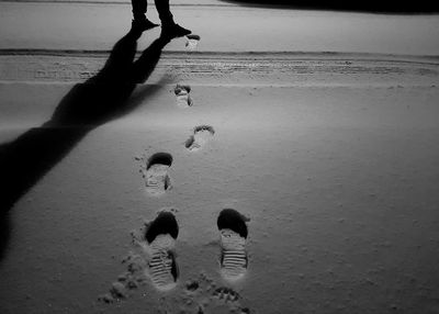 Low section of men playing on beach