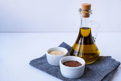 Sesame and flax seeds with oil in glass bottle. healthy food concept. vegan keto diet. healthy eat