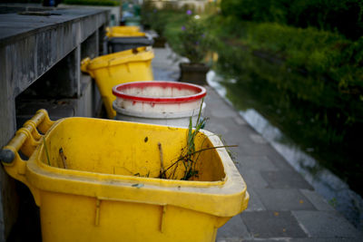 Close-up of yellow container on street