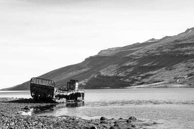 Scenic view of lake and mountains against clear sky
