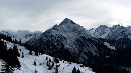 Scenic view of snow covered mountains against sky