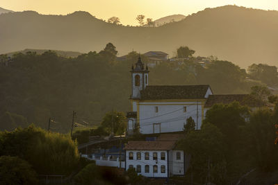 Sunset in the historic city of ouro preto in minas gerais with its churches and mountains