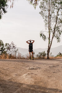 Rear view of woman walking on road