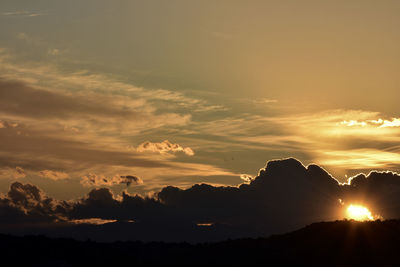 Scenic view of silhouette mountains against sky during sunset