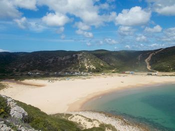 View of beach against cloudy sky