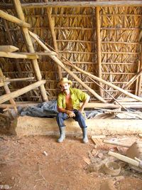 Portrait of farmer sitting in barn