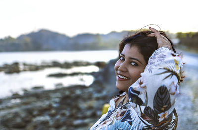 Portrait of a smiling young woman outdoors