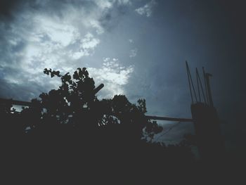 Low angle view of silhouette trees against sky