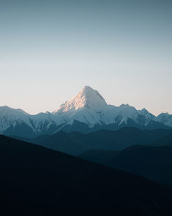 Scenic view of snowcapped mountains against clear sky