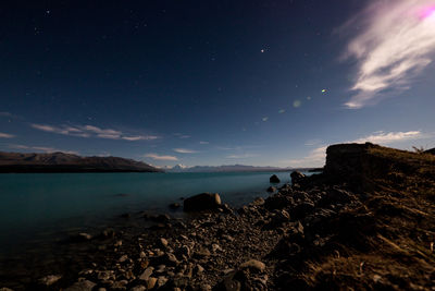 Scenic view of sea against sky at night