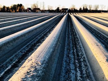 Railroad tracks against sky during winter