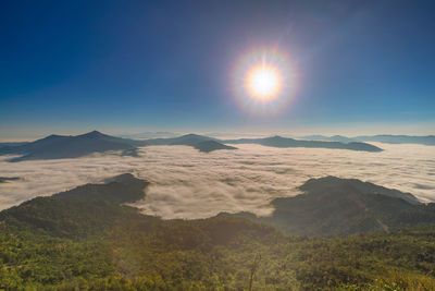 Scenic view of mountains against bright sun