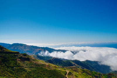 Scenic view of mountains against blue sky